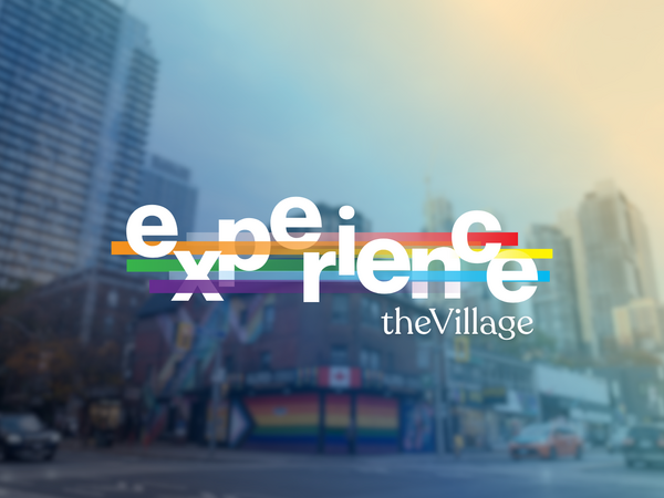 Church-Wellesley intersection street scene with buildings, one painted in rainbow colours, and the words "Experience The Village" overlaid in white text with interweaving rainbow stripes.